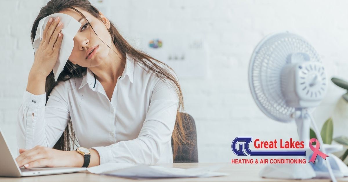 Adult woman sweating due to AC problems.