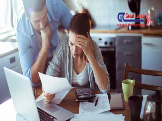 Two people look worried at their bill